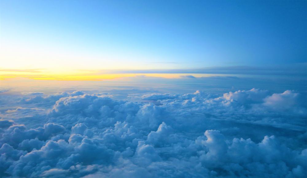 A breathtaking view of clouds at sunset, inspiring the dream of becoming a pilot through flight school and training.